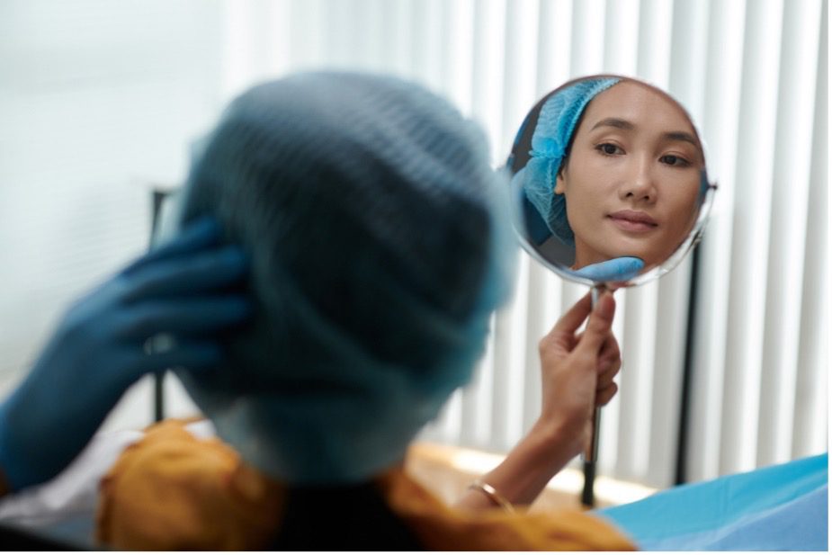 A person looking at her face in a mirror