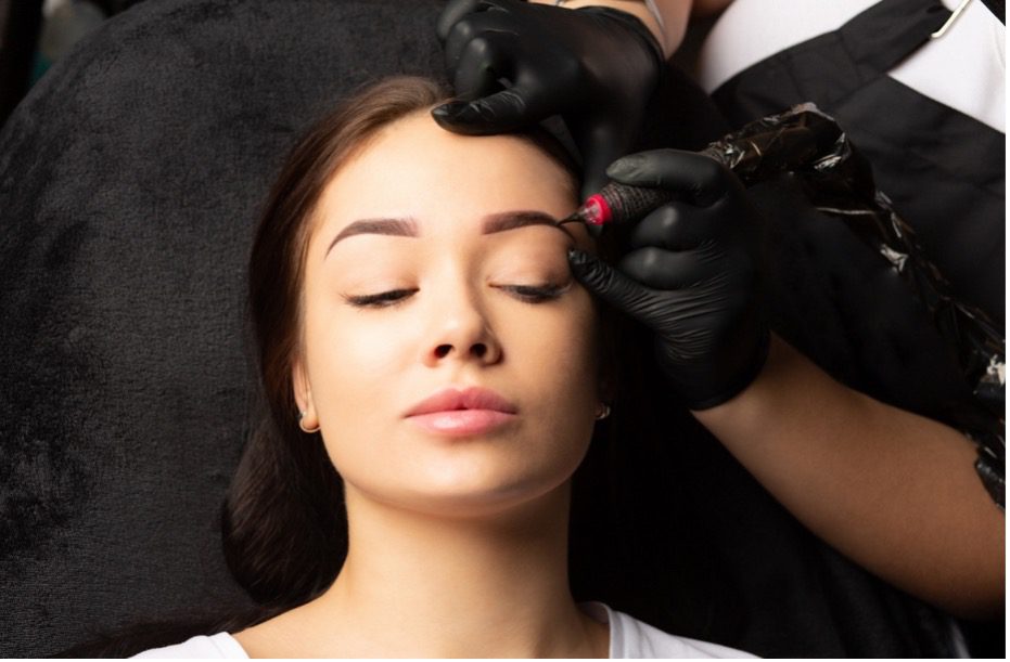 A person getting her eyebrows done