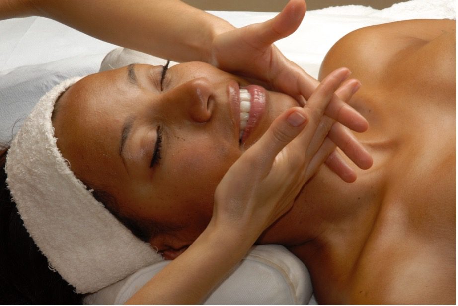 A person receiving a face massage