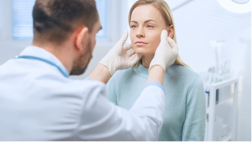 A doctor touching a person's face